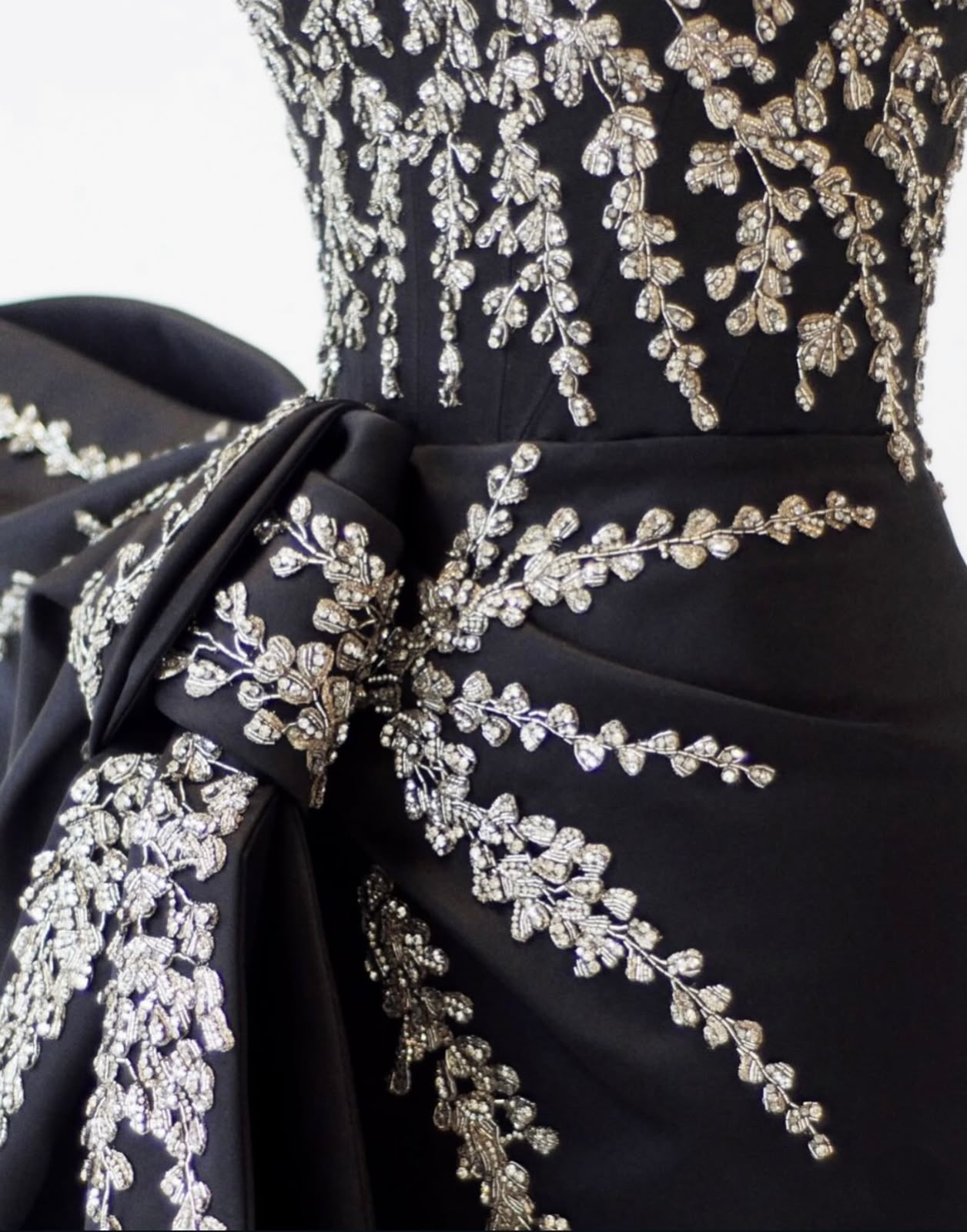 Close-up of botanical beadwork on Ariana Grande’s black Givenchy stage look